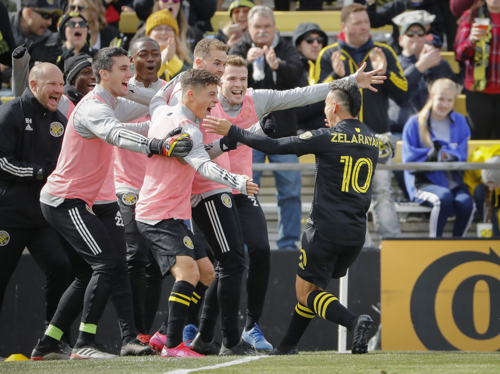 Third Place, Ron Kuntz Sports Photographer of the Year - Adam Cairns / The Columbus DispatchTeammates mob Columbus Crew SC forward Lucas Zelarayan (10) after he scored a goal during the second half of the MLS match against New York City at Mapfre Stadium in Columbus on Sunday, March 1, 2020. The Crew won 1-0. 