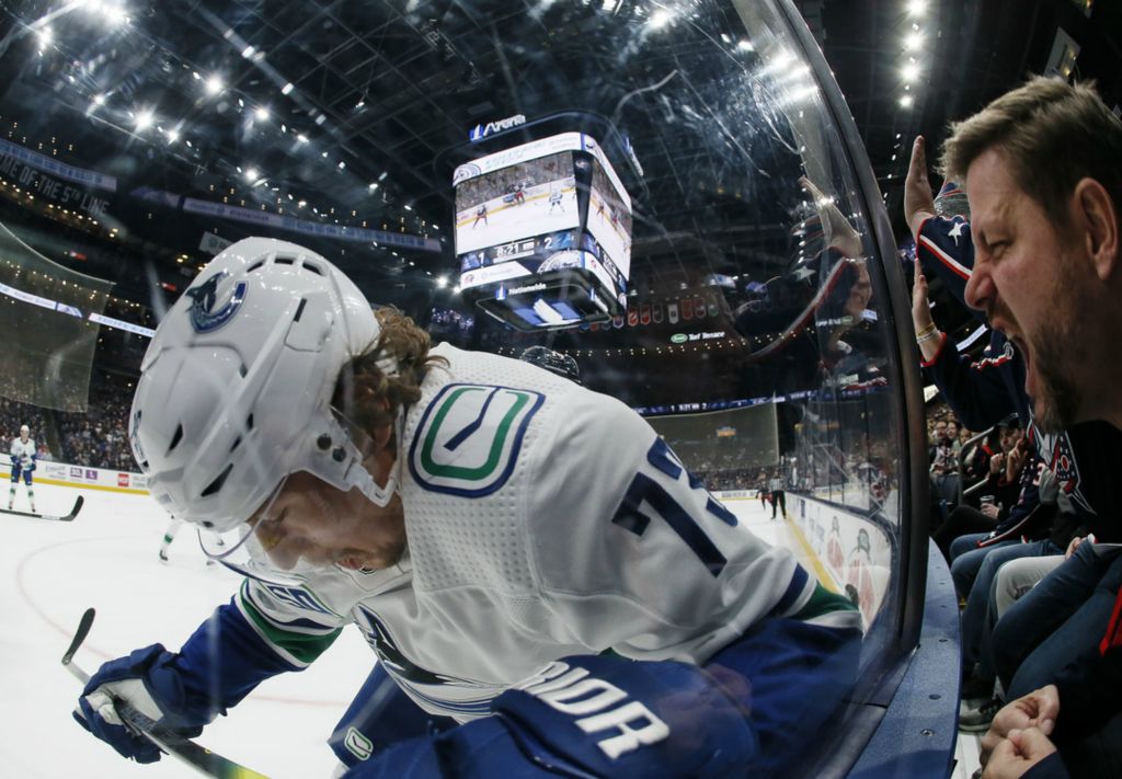 Third Place, Ron Kuntz Sports Photographer of the Year - Adam Cairns / The Columbus DispatchJohn Ness of Upper Arlington yells at Vancouver Canucks forward Tyler Toffoli (73) during the first period of the NHL hockey game at Nationwide Arena in Columbus on Sunday, March 1, 2020.