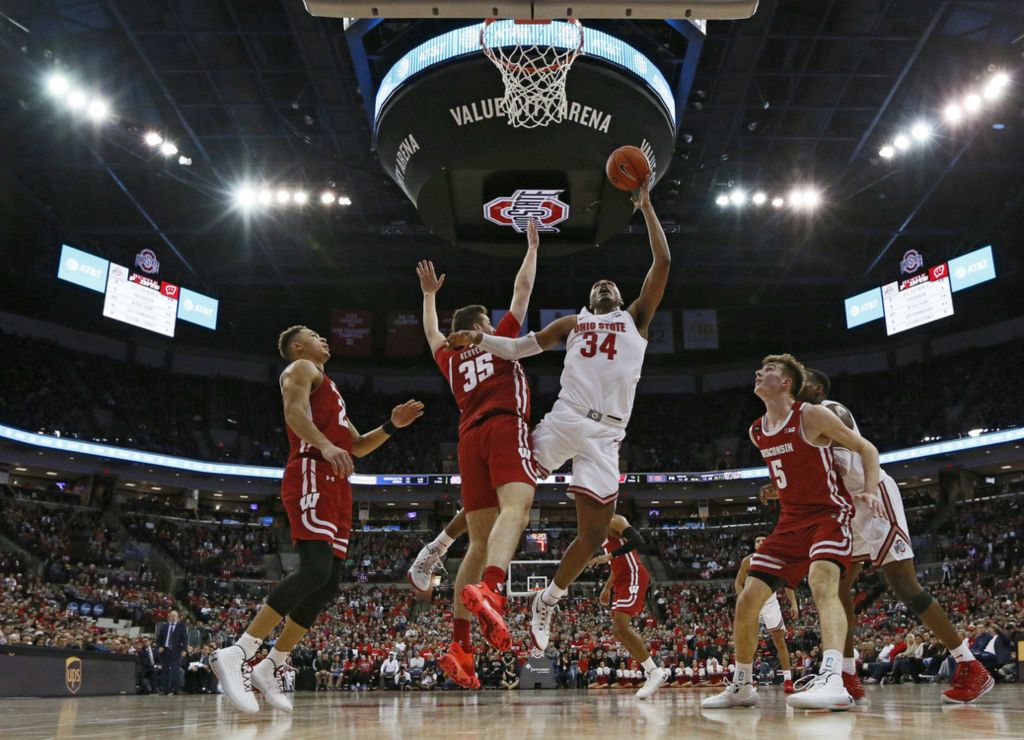 Third Place, Ron Kuntz Sports Photographer of the Year - Adam Cairns / The Columbus DispatchOhio State Buckeyes forward Kaleb Wesson (34) puts up a shot defended by Wisconsin Badgers forward Nate Reuvers (35) during the second half of the NCAA men's basketball game at Value City Arena in Columbus on Friday, Jan. 3, 2020. Ohio State lost 61-57. 