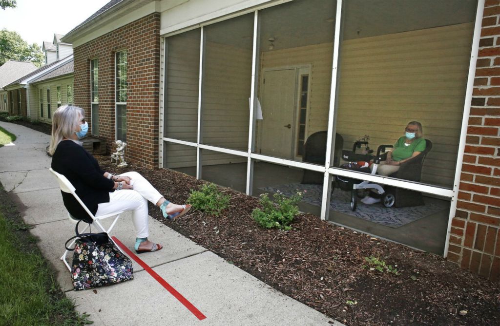 First Place, Team Picture Story - Fred Squillante / The Columbus Dispatch, “Social Distancing”Assisted living facility visits are now allowed again after months of being prohibited because of the coronavirus. Janice Weiser, left, visits with her mother, Virginia Balk, right, at Abbington of Arlington on Old Henderson Road in Columbus on Friday, June 19, 2020. 