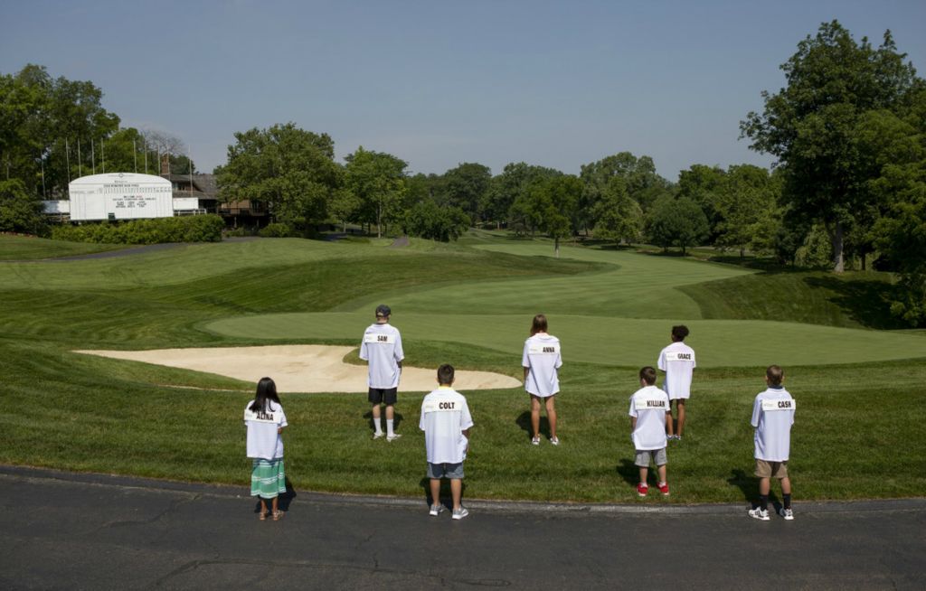 First Place, Team Picture Story - Adam Cairns / The Columbus Dispatch, “Social Distancing”Nationwide Children's Hospital Patient Champions, from left, Alina Krishnasetty, 8, Colt Marcum, 11, Sam Short, 14, Killian Madrid, 10, Anna Earl, 15, Cash Miller, 11, and Grace Kirura, 8, look out on the 18th green as they stand for a portrait during the visit to Muirfield Village Golf Club in Dublin on Tuesday, June 30, 2020. Instead of the kids visiting the golf course during the week of the Memorial Tournament presented by Nationwide, the kids and their families got to experience the course a few weeks early due to coronavirus restrictions the week of competition. 