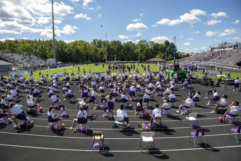 First Place, Team Picture Story - Adam Cairns / The Columbus Dispatch, “Social Distancing”The Pickerington Central marching band sits socially distanced during the high school football game againts Pickerington North at Tiger Stadium in Pickerington, Ohio on Sunday, Aug. 30, 2020.
