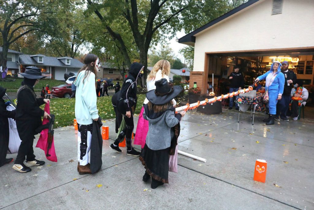 First Place, Team Picture Story - Fred Squillante / The Columbus Dispatch, “Social Distancing”A clever way to maintain social distance from trick or treaters was used at Gary and Jaymie Clark's home in Gahanna on Thursday, October 29, 2020. Candy was blown to the children through a long tube. Operating the blower is family friend, Kendra Stewart.