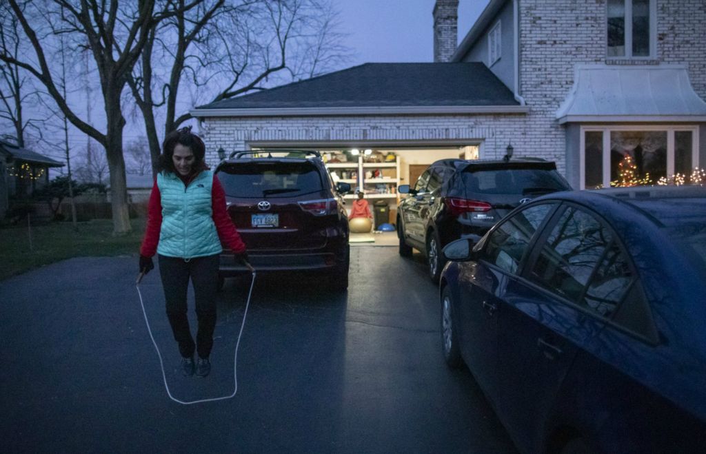 First Place, Team Picture Story - Adam Cairns / The Columbus Dispatch, “Social Distancing”Olga Stavridis, 53, jump ropes in the driveway of her neighbor, Donna Reda, while working out with personal trainer Caitlin Kennelly in the garage of Reda's Upper Arlington home on Tuesday, Dec. 15, 2020.