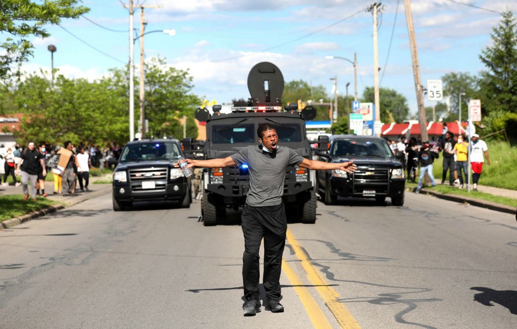 Second Place, Team Picture Story - Amy E. Voigt / The Blade, “Protests Erupt”A protestor, who was doused in tear gas, tries to move the crowd off of Bancroft Street  as Toledo police try to disperse protestors on Saturday, May 30, 2020.  People gathered in Toledo to protest the death of George Floyd in Minneapolis.