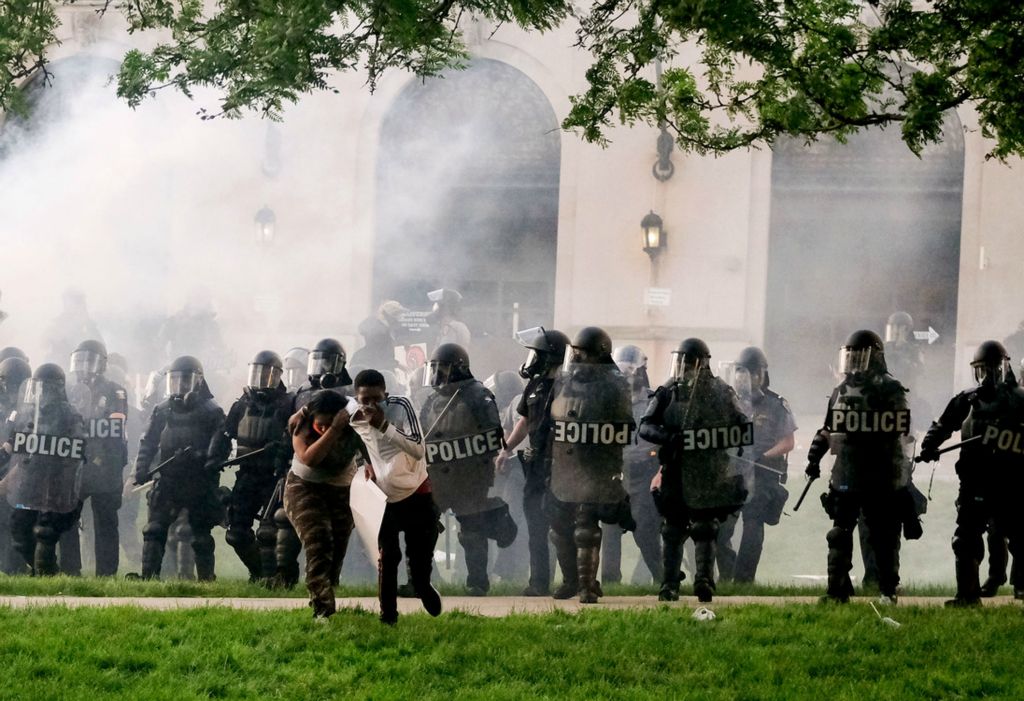 Second Place, Team Picture Story - Kurt Steiss / The Blade, “Protests Erupt”Two people scatter as police deploy tear gas near the Lucas County Courthouse during a protest in Toledo on Saturday, May 30, 2020. People gathered to protest the killing of George Floyd in Minneapolis.