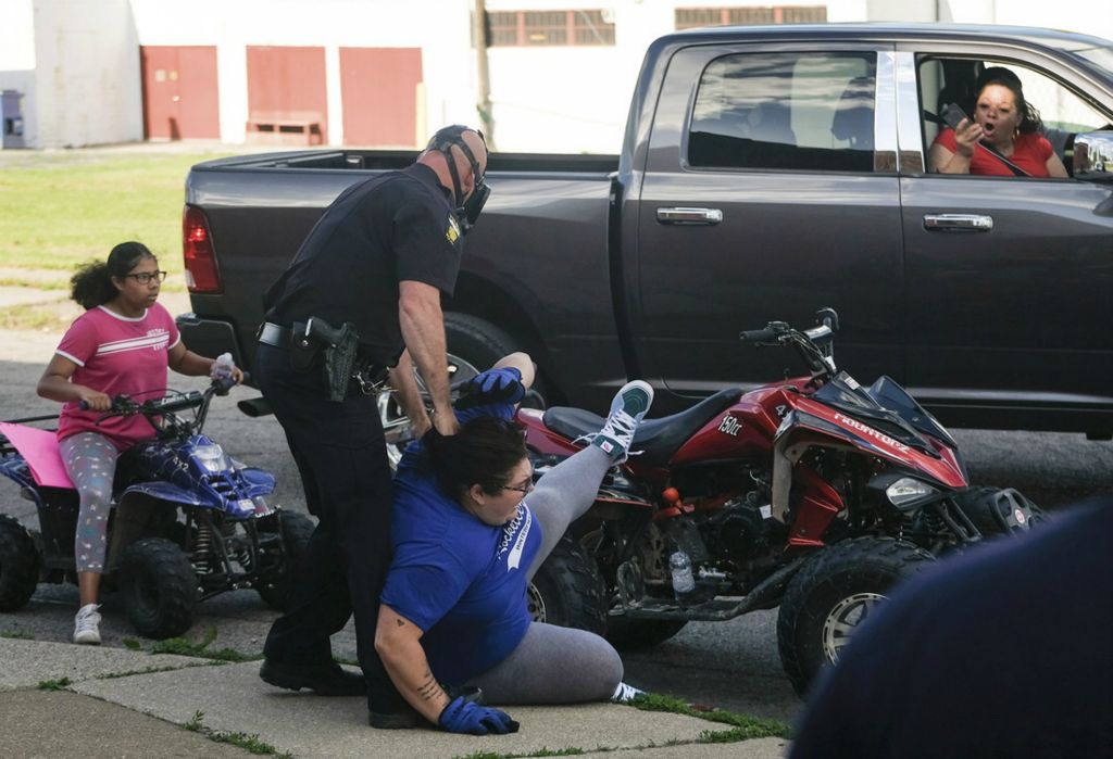 Second Place, Team Picture Story - Kurt Steiss / The Blade, “Protests Erupt”A police officer pulls Myranda Johnson off of her four wheeler during a protest in Toledo on Saturday, May 30, 2020. People gathered around downtown to protest the killing of George Floyd in Minneapolis.