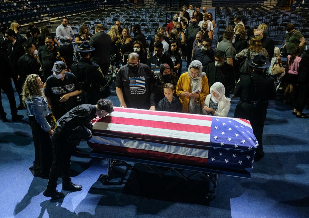 First Place, Team Picture Story - Jeremy Wadsworth / The Blade, “Officer Killed”Family members and friends pay their respects during a funeral for slain Toledo Police Officer Anthony Dia Tuesday, July 7, 2020, at Savage Arena.
