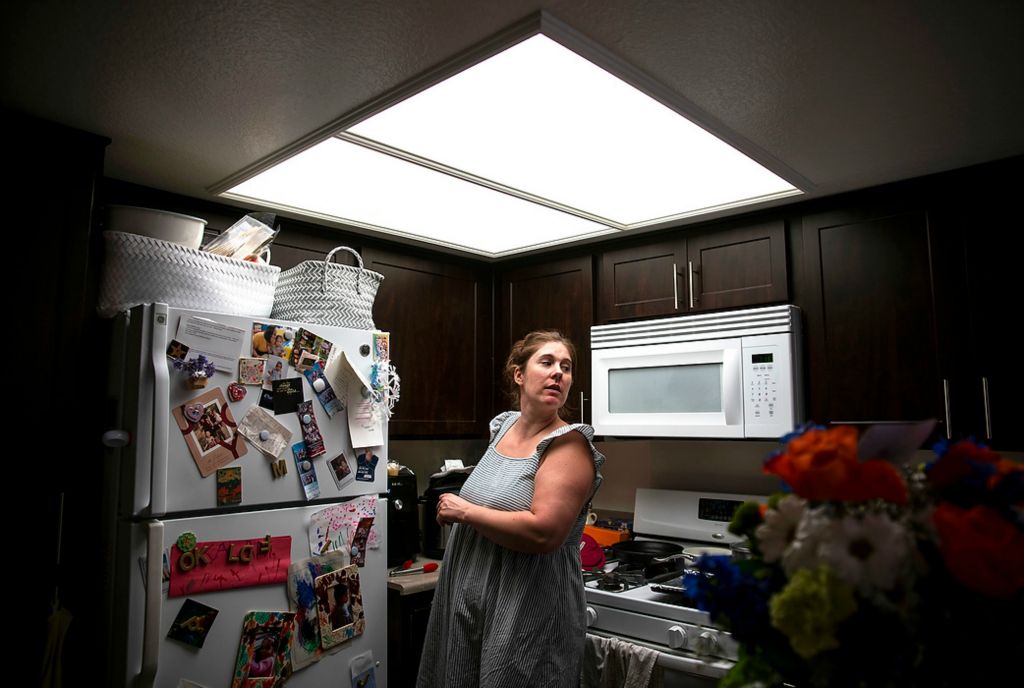 First place, Chuck Scott Student Photographer of the Year - Erin Burk / Ohio UniversityKristina looks at her daughters from the kitchen while she meal preps on June 6, 2021. Meal prepping helps her keep from feeling like she spends all her time in the kitchen.