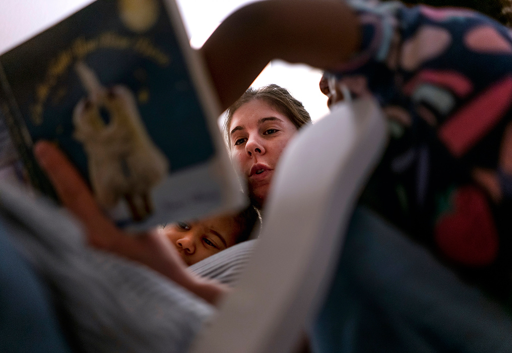 First place, Chuck Scott Student Photographer of the Year - Erin Burk / Ohio UniversityKristina reads Okalani and Zoë a story before bedtime on June 6, 2021.
