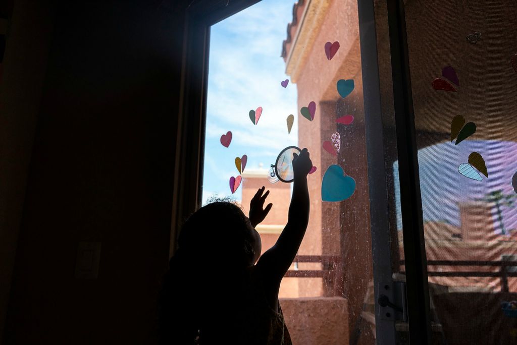 First place, Chuck Scott Student Photographer of the Year - Erin Burk / Ohio UniversityOkalani plays with a toy on the window at their home on June 5, 2021. The family looks forward to being safe in public again.