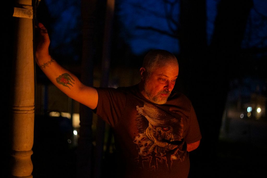 Second place, Chuck Scott Student Photographer of the Year - Chris Day / Ohio UniversityJohn Moore leans against his porch as he stares into a fire outside of his home in New Marshfield on Sunday, April 4, 2021. Moore said he and his family often sit by the fire to talk and eat dinner. "Get some pizza go out by the fire and tell lies," he said.