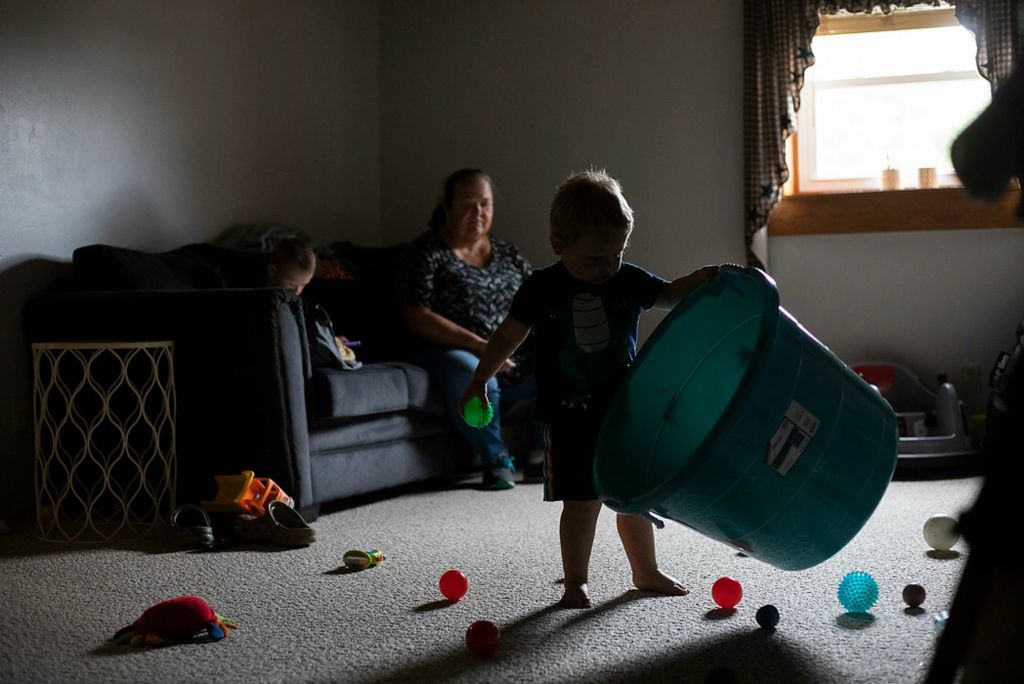 Second place, Chuck Scott Student Photographer of the Year - Chris Day / Ohio UniversityDanita McLaughlin watches as Mangus Shaulis plays in the toy room downstairs while his brother, Silas, watches videos on his tablet on Sept. 24, 2021. "I'm sometimes dead after I leave here," she said