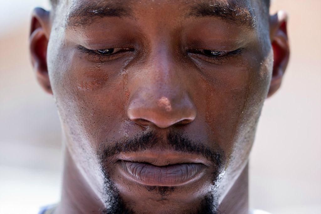 Second place, Chuck Scott Student Photographer of the Year - Chris Day / Ohio UniversityBam Adebayo, a Miami Heat basketball player, has tears stream down his face as he answers questions after visiting the makeshift memorial for those missing on Friday, July 2, 2021. The memorial is across the street from the 12-story oceanfront Champlain Towers South Condo, at 8777 Collins Ave., that partially collapsed around 2 a.m. on Thursday, June 24, 2021 in Surfside, Fl.
