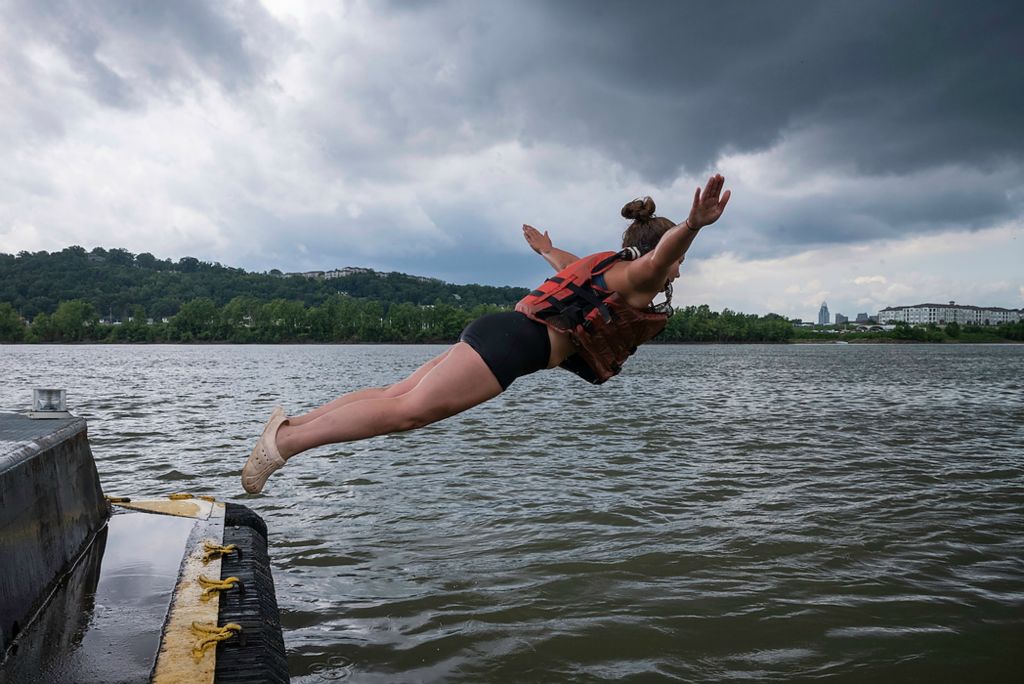 Second place, Feature Picture Story - Joshua A. Bickel / The Columbus Dispatch, "Our Rivers’ Keepers"After finishing her work for the day, Callie Schafer leaps off the barge into the Ohio River. A self-described “lazy bum” before joining the crew, Schafer found herself back home in Illinois with her parents after a stint as a drummer in Oregon. A friend suggested she might be a good fit for the crew, which is based in the nearby Quad Cities. “I kinda just went balls to the walls,” she said. “Baptize by fire, I guess.”