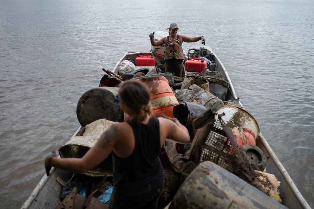 Second place, Feature Picture Story - Joshua A. Bickel / The Columbus Dispatch, "Our Rivers’ Keepers"Callie Schafer (background) and Rachel Loomis, foreground, do a dance in their boat after successfully hauling some trash out of the river. “There’s only so much I can do as a human,” Schafer said. “You can’t tackle everything, but when we’re just focused, as a crew, on garbage, it’s helpful.”