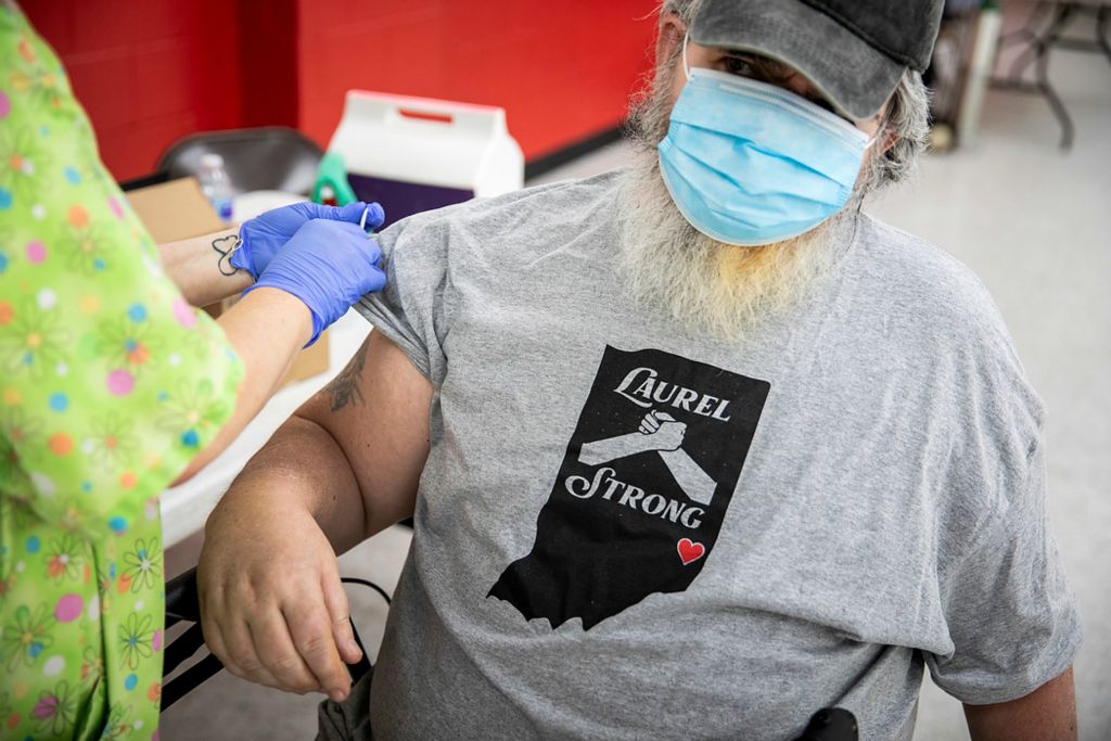 Third place, Feature Picture Story - Meg Vogel / The Cincinnati Enquirer, "Vaccine Hesitancy"Angie Ruther, a registered nurse with the Franklin County Health Department, administers the Johnson & Johnson COVID-19 vaccine to Randel Blake at the Laurel Community Center on June 7, 2021.  
