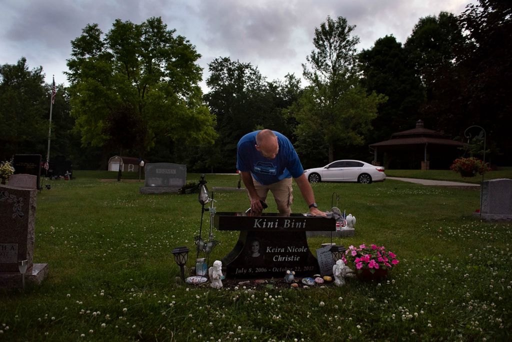 Award of Excellence, Feature Picture Story - Alie Skowronski / Ohio University, "New Normal"Keira’s father, Scott, wipes off her tomb stone in Stow, Ohio, on June 9, 2021. Scott and Kristy both visit Keira’s grave once a week. “Now this is our new normal, we try to stay busy. But we get to see Joslynn live her life. Keira will help her grow up,” said Kristy.