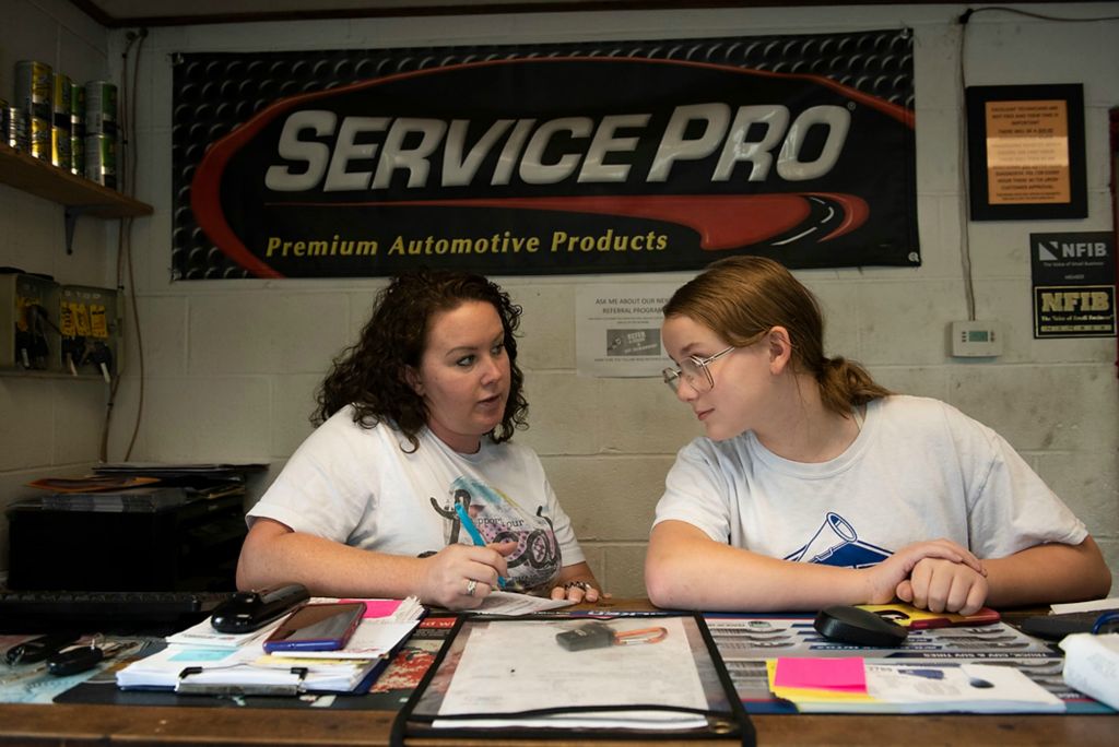 Award of Excellence, Feature Picture Story - Alie Skowronski / Ohio University, "New Normal"Joslynn rolls her eyes at her mother, Jodi Mowery while she takes her lunch order at the front desk in their family’s auto repair shop called AJ’s Automotive Service in Minford, Ohio, on June 7, 2021. Jodi told Joslynn that she could not have a hamburger, and Joslynn got annoyed. “Joss don’t know how they cook their burgers, sorry sis, but I don’t know if it’ll be cooked all the way through,” said Jodi. 