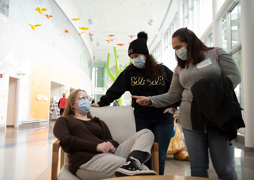 Award of Excellence, Feature Picture Story - Alie Skowronski / Ohio University, "New Normal"Kristy, Keira’s mom (right) make sure Joslynn tells her mother, Jodi, center, everything the doctors mentioned during Joslynn’s bi-yearly checkup at Nationwide Children’s Hospital in Columbus on Dec. 27, 2021. The families worked with the hospital to allow Keira’s parents to take Joslynn to her appointment and act as ‘parental guardians.’ “We can’t do much for them, but this is a way of saying thank you. It’s not only our girl, but it’s their girl now, too,” said Jodi. 