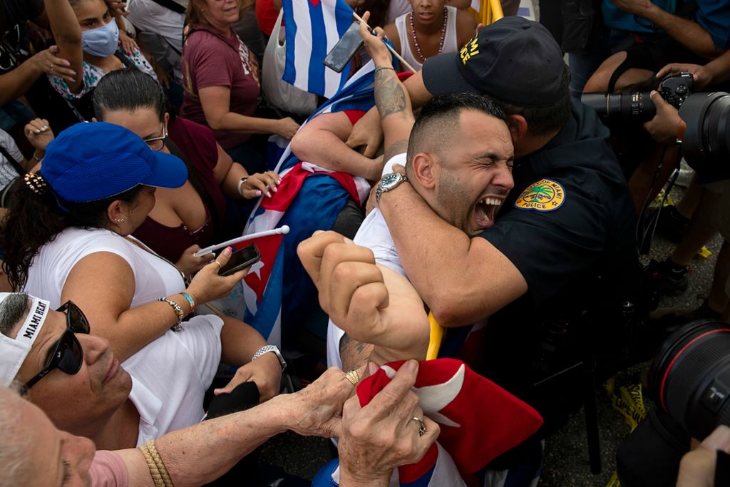 First place, General News - Chris Day / Ohio University, "Miami Protest"An audience member is comforted by Miami Police Chief Art Acevedo during a mini-concert from local Cuban-American artists on July 14, 2021. The event was put on by the City of Miami to show support to the people in Cuba who are protesting for freedom.