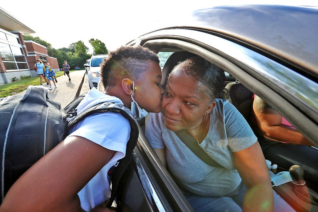 Second place, General News - Bill Lackey / Springfield News-Sun, "Kiss"Sean Kidd gives his grandmother, Kim Martin, a kiss goodbye as he gets dropped off for the first day of school at Lagonda Elementary School. 
