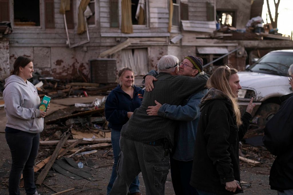 Award of Excellence, News Picture Story -  / , "Tornado"Tommy Anderson (left) embraces his friend, Ralph Hale (right) after they spent the day removing personal items from Anderson’s home. The Anderson family was helped by friends and family after their home was destroyed by the tornado on Friday night. The two have been friends for about 5 years.