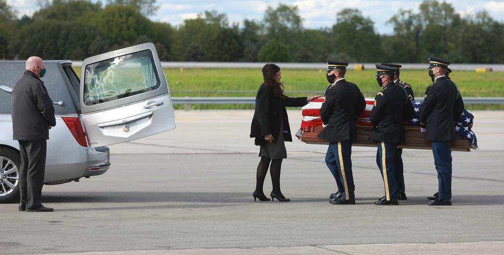 Award of Excellence, News Picture Story - Doral Chenoweth / The Columbus Dispatch, "Kaylie Harris"Carey Harris talks with her daughter Kaylie as casket bearers prepare to place her body in a hearse for the ride from John Glenn International Airport in Columbus to a funeral home in Springfield on May 11, 2021. Kaylie Harris was an Army MP stationed in Anchorage. She alleged that she was raped by a colleague, an Airman, in January shortly after coming out on social media. Harris's family believes the rape was also a hate crime directed at her because she was lesbian. She printed a suicide note on May 2, 2021 and was found with a gunshot wound to her head. 