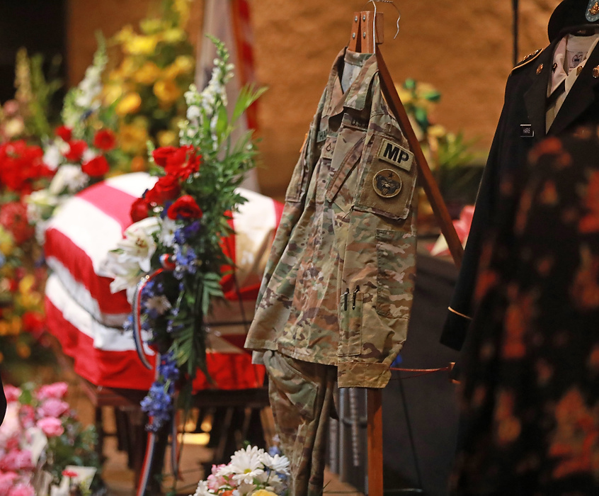 Award of Excellence, News Picture Story - Doral Chenoweth / The Columbus Dispatch, "Kaylie Harris"The uniforms of Kaylie Harris are hung beside her casket during her funeral service held  May 15, 2021 at the First Christian Church in Springfield, Ohio. Harris was an Army MP stationed in Anchorage. She alleged that she was raped by a colleague, an Airman, in January shortly after coming out on social media. Harris's family believes the rape was also a hate crime directed at her because she was lesbian. She printed a suicide note on May 2, 2021 and was found later that day with a gunshot wound to her head. 