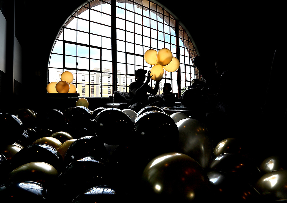 Second place, Pictorial - Bill Lackey / Springfield News-Sun, "Balloons "The second floor of the Springfield COhatch is filled with gold, silver and black balloons as the family of Jamon Miller inflates dozens of balloons for a party celebrating Miller's graduation from Shawnee High School. 