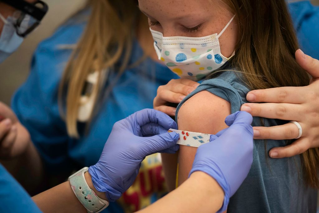 First place, Photographer of the Year - Large Market - Joshua A. Bickel / The Columbus DispatchMarin Ackerman, 10, of Upper Arlington, Ohio, gets a bandage after receiving a dose of the Pfizer-BioNTech COVID-19 vaccine during a clinic for kids ages 5 to 11-year-olds on Nov. 3, 2021 at Nationwide Children's Hospital in Columbus, Ohio. The FDA recently approved use of the Pfizer-BioNTech COVID-19 vaccine for use in children.