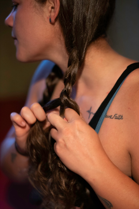 First place, Photographer of the Year - Large Market - Joshua A. Bickel / The Columbus DispatchCallie Schafer braids her hair before work in the morning. On her chest is a tattoo with the words “Have Faith” and her father’s EKG. In high school, her father had a heart transplant, and she got the tattoo before his operation. Her work on the barge fulfills her desire to be intentional in life.