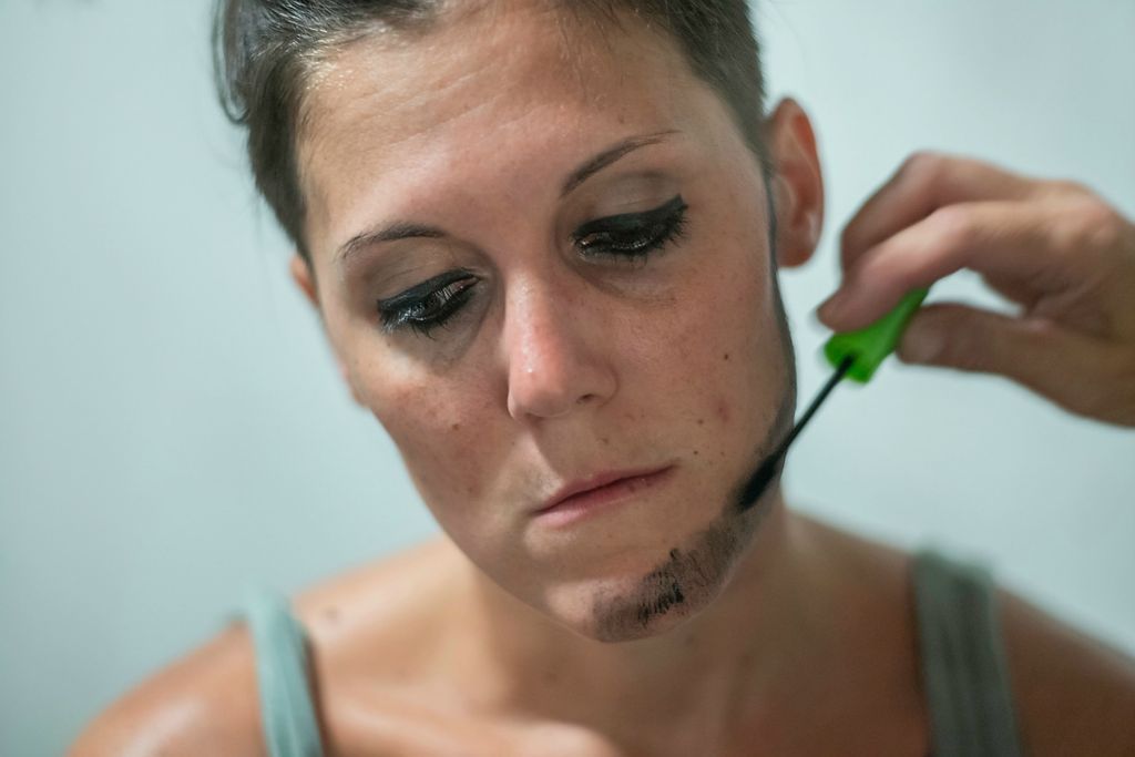 First place, Photographer of the Year - Large Market - Joshua A. Bickel / The Columbus DispatchJess sits still as Cat uses mascara to paint a beard on her chin before the start of the drag show on August 21, 2021 in Chillicothe, Ohio. Cat is the only person Jess trusts to do her makeup when she performs.