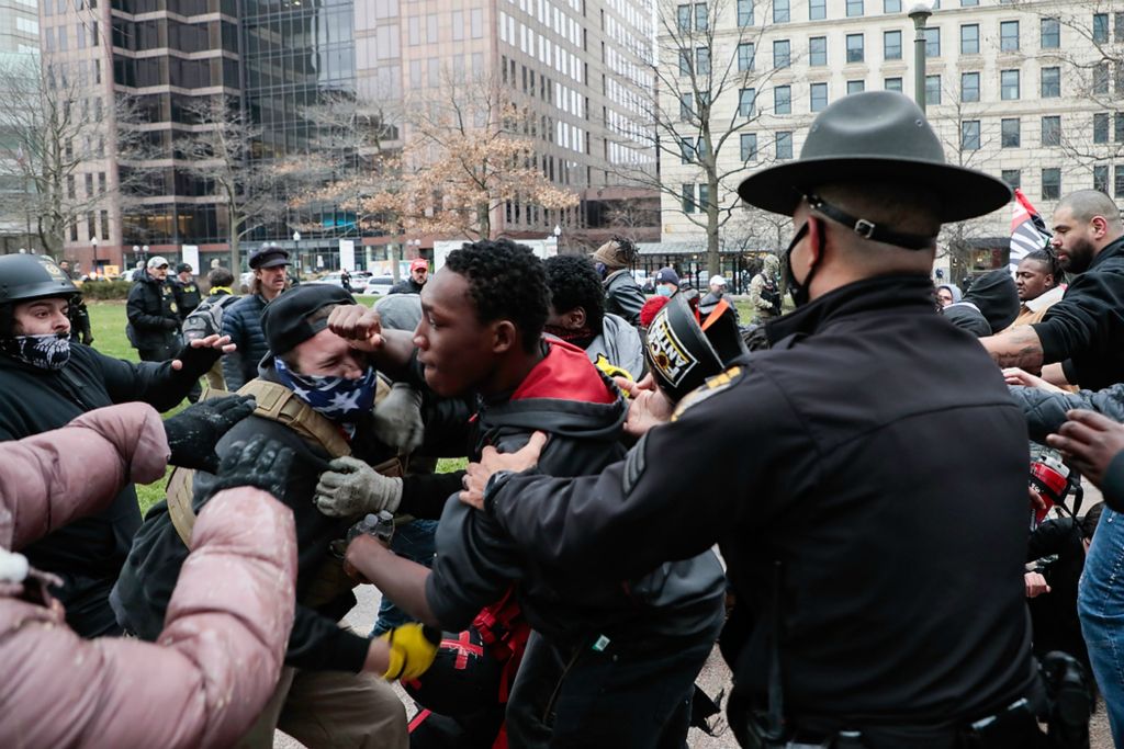 First place, Photographer of the Year - Large Market - Joshua A. Bickel / The Columbus DispatchCounterprotestors and Trump supporters brawl as law enforcement officials intervene during a “Stop the Steal” rally on Jan. 6, 2021 at the Ohio Statehouse in Columbus, Ohio. Hundreds of supporters of President Donald Trump, including members of the Proud Boys, a far-right, male-only political organization, came to the Statehouse to protest the congressional certification of Democratic President-Elect Joseph R. Biden Jr., who defeated the incumbent Republican President Trump during the November 2020 elections and whose victory was certified by the Electoral College in December 2020.