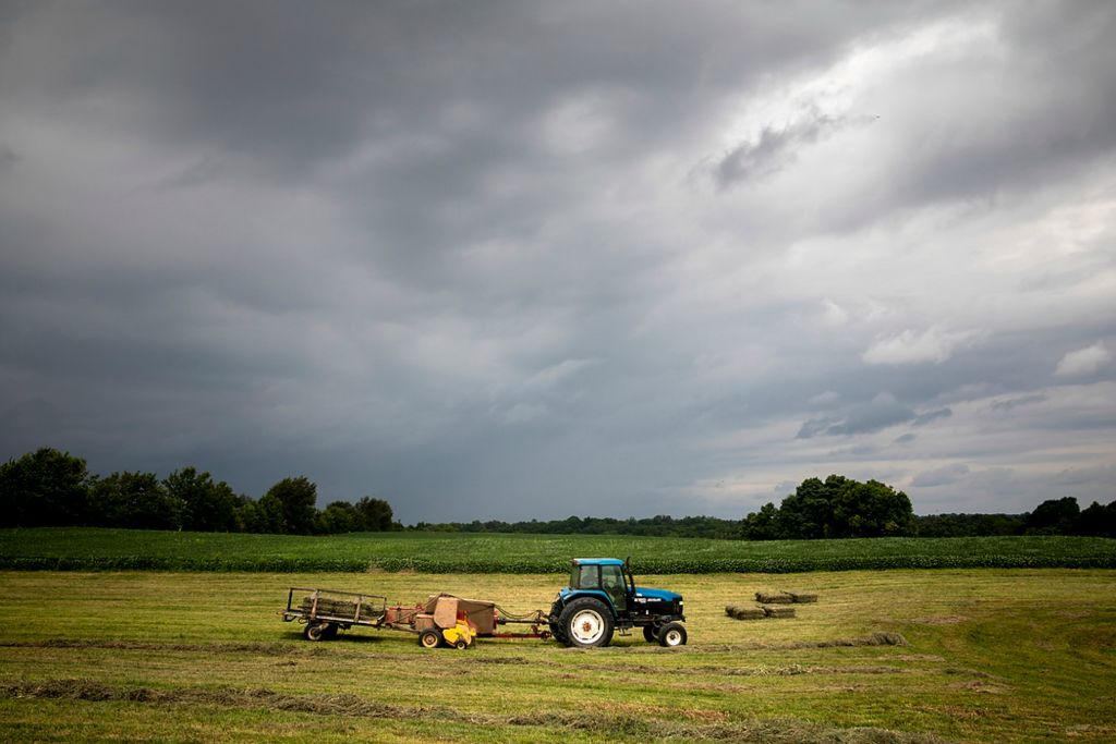 Second place, Photographer of the Year - Large Market - Meg Vogel / The Cincinnati EnquirerTroy Bradford operates a hay baler on his farm in Harrison County, Ky., on Monday, August 9, 2021. Bradford is leasing 200 acres of his farm for solar panels. Solar energy represents a change for Kentucky, whose economic prospects have long been tied to labor-intensive industries like coal and tobacco. But that change is coming, through tax credits, infrastructure deals and climate change incentives. According to Reuters, the Biden administration hopes solar could power 40% of the U.S. by 2035. That means a massive transition world, nation and region-wide. Community solar projects have been authorized in 19 states, and farmers around the country are making the switch. In Harrison County, that vision of the future is not yet a reality. The solar future is more personal than money or energy for this community. No one wants to lose the land where they've invested their lives. 