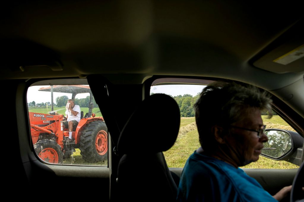 Second place, Photographer of the Year - Large Market - Meg Vogel / The Cincinnati EnquirerPam McCauley drives around her farm in Harrison County, Ky., on Wednesday, August 25, 2021, to show what fields will be leased for solar panels as her husband mows the field. "I'm going to be 65," she said. "I don't have any heirs. I don't know what else I can do. I have got to find some way that we can keep the family farm...and still have it profitable."