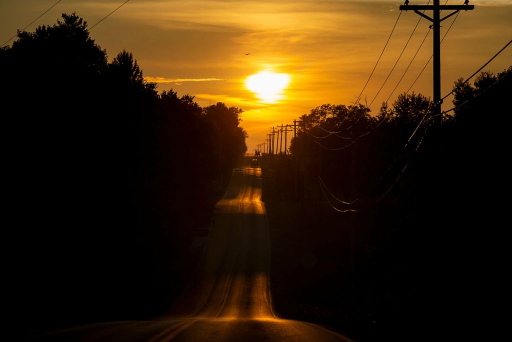 Second place, Photographer of the Year - Large Market - Meg Vogel / The Cincinnati EnquirerVehicles travel in Harrison County, Ky., as the sun sets on Wednesday, August 25, 2021. To stave off the worst effects of the climate emergency, the United Nations Intergovernmental Panel on Climate Change estimates the planet will need 85% of its energy to come from renewable sources by 2050. 