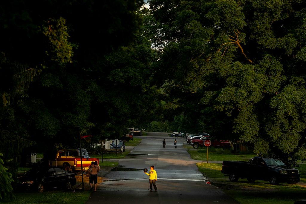 Second place, Photographer of the Year - Large Market - Meg Vogel / The Cincinnati EnquirerA boy plays basketball outside his home down the street from a temporary vaccination clinic at the Laurel Community Center on Monday, June 7, 2021 in Laurel, Indiana. Franklin County has 23,000 residents. Fear, distrust and politics still dominate conversations about the vaccine among Franklin County's residents. The skeptics say they worry about the speed of vaccine development and the uncertainty of long-term health effects. Some repeat disproven conspiracy theories involving infertility, aborted fetal tissue and plots against former President Donald Trump.