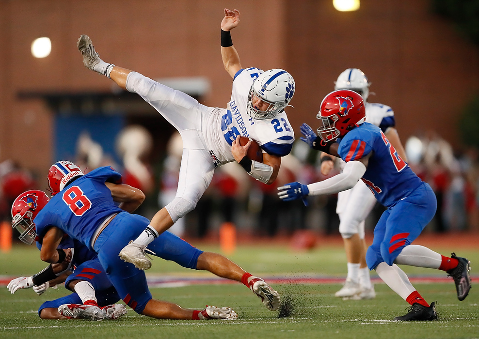 Third place, Photographer of the Year - Large Market - Adam Cairns / The Columbus DispatchHilliard Davidson Wildcats running back Jonny Weir (22) gets upended by Thomas Worthington Cardinals defensive back Connor Smith (8) before being hit by linebacker Bernard Oteng Jr. (24) during the second quarter of the OHSAA football game at Thomas Worthington on Sept. 17, 2021