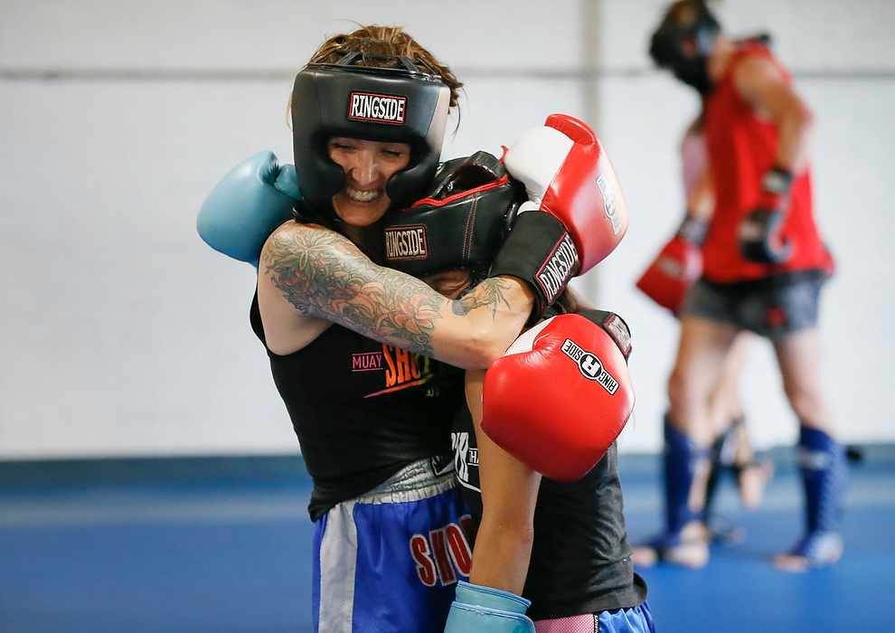 Third place, Photographer of the Year - Large Market - Adam Cairns/Columbus Dispatch / After sparring, Lyndsie MacNeer hugs fellow student Esther Hall at Short North Muay Thai on Sept. 1, 2021. 