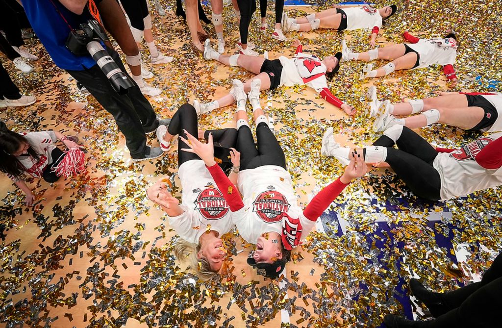 Third place, Photographer of the Year - Large Market - Adam Cairns/Columbus Dispatch / Wisconsin Badgers players play in the confetti following their five set win over the Nebraska Cornhuskers in the NCAA volleyball national championship at Nationwide Arena in Columbus on Dec. 19, 2021.