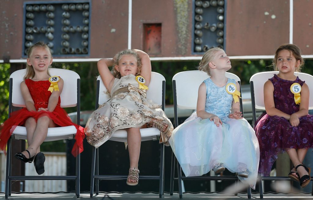 Third place, Photographer of the Year - Large Market - Adam Cairns / The Columbus DispatchOxy Sweehearts contestants (from left) Emi Herring, A'Mara Little, Mina Holden and Campbell Patterson squirm in the chairs while waiting for the judges to tabulate the final results from the judges during the Ox Roast in West Jefferson, Ohio on Sept. 6, 2021. Patterson eventually was named the winner. 