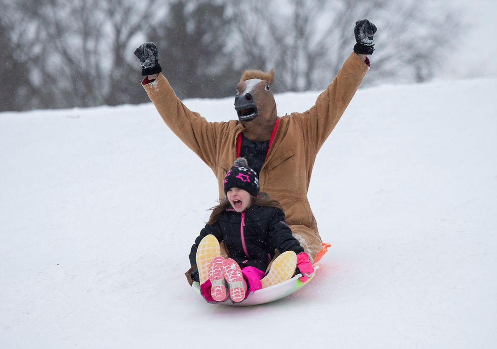 Third place, Photographer of the Year - Large Market - Adam Cairns / The Columbus DispatchNoelle Thyret, 8, of Dublin screams while sledding down the hill at Antrim Park with her mother's horse mask wearing fiancé, Nick Quast, 39, of Cleveland on Feb. 15, 2021.