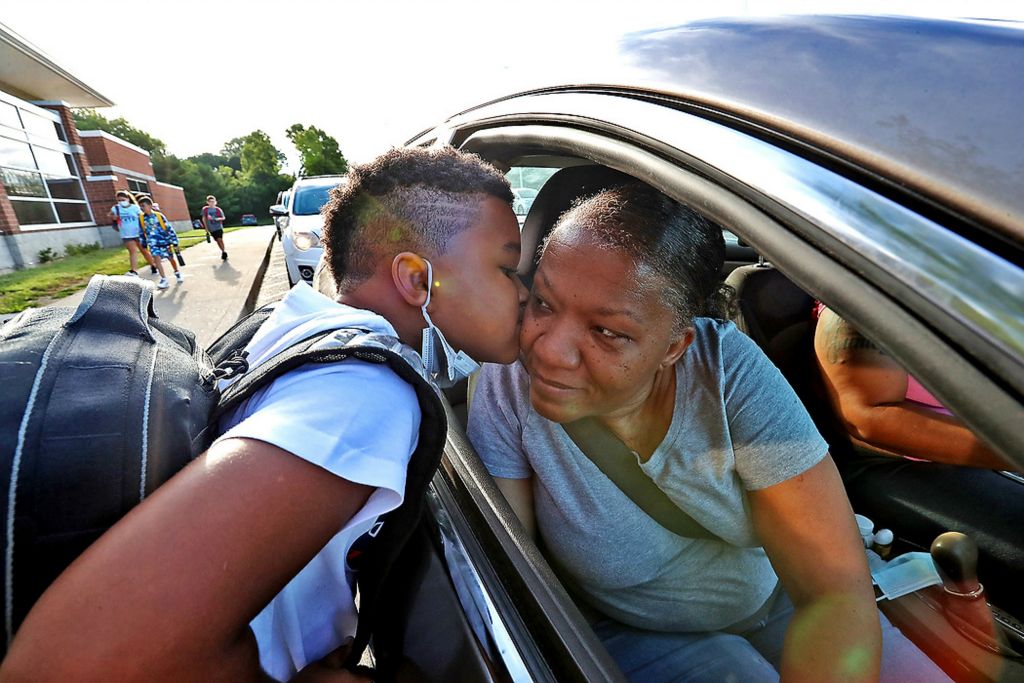 First place, Photographer of the Year - Small Market - Bill Lackey / Springfield News-SunSean Kidd gives his grandmother, Kim Martin, a kiss goodbye as he gets dropped off for the first day of school at Lagonda Elementary School.