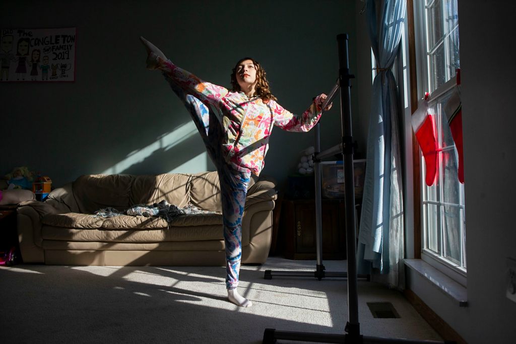 Second place, Portrait Personality - Alie Skowronski / The Columbus Dispatch, "Phoebe Congleton"Phoebe Congleton, 12, stretches before ballet practice in her living room in London, Ohio, on Dec. 8, 2021. Congleton is a back up Clara in BalletMet’s production of the nutcracker this year. All participants in the nutcracker had to be 12-years-old because vaccination was a requirement.
