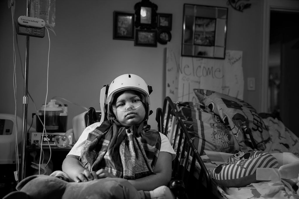 Award of Excellence, Portrait Personality - Meg Vogel / The Cincinnati Enquirer, "MJ"Marcellus "MJ" Whitehead, 8, sits in his wheelchair at his grandma's house in Evanston on November 12, 2021. In July, MJ was shot in the head and leg while leaving his neighborhood corner store with his older brother. For months, MJ has been receiving treatment at Cincinnati Children's Hospital for a severe brain injury. MJ left the hospital earlier this week, but still requires constant care from his grandmother and mother.