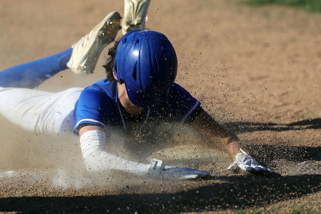 Award of Excellence, Sports Action - Shane Flanigan / ThisWeek Community News, "Blind Slide"Grove City Christian's Jake Bapst slides safely into third base for a triple as his helmet falls over his face during a game against Millersport on April 26, 2021, at Grove City Christian School.