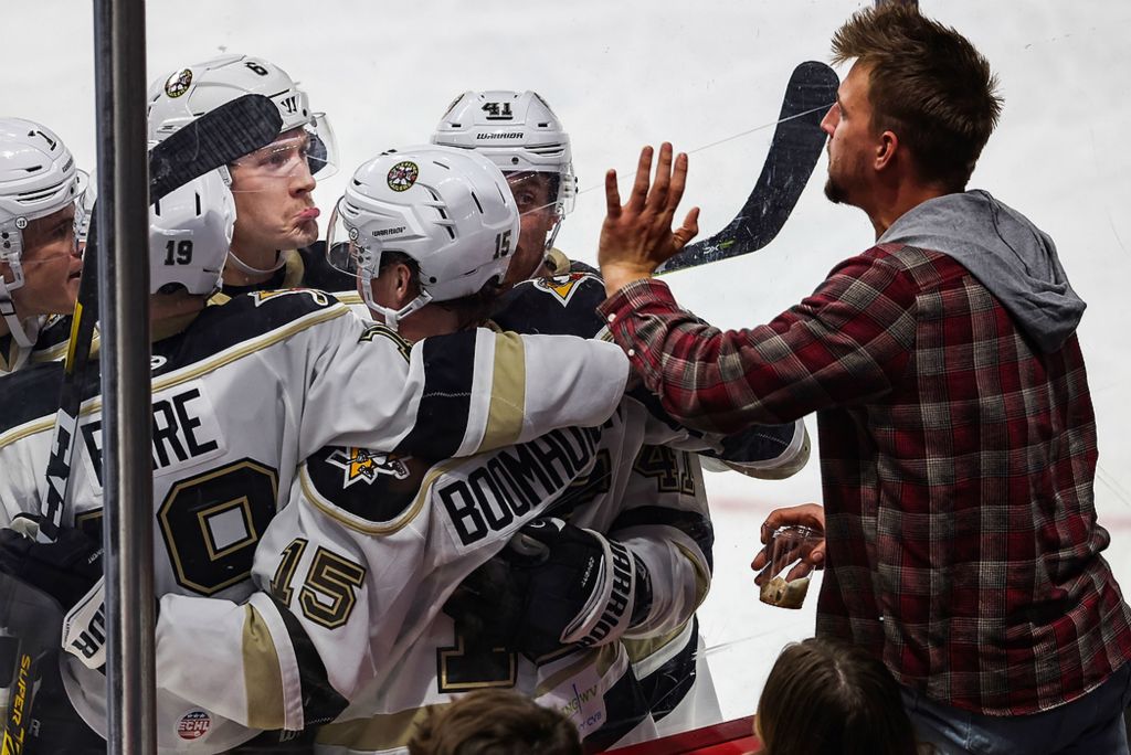 First place, Sports Feature - Rebecca Benson / The Blade, "Mocking"Wheeling’s team mocks a Walleye fan after scoring their third goal during the second period an ECHL game at the Huntington Center in Toledo on November 12, 2021. 