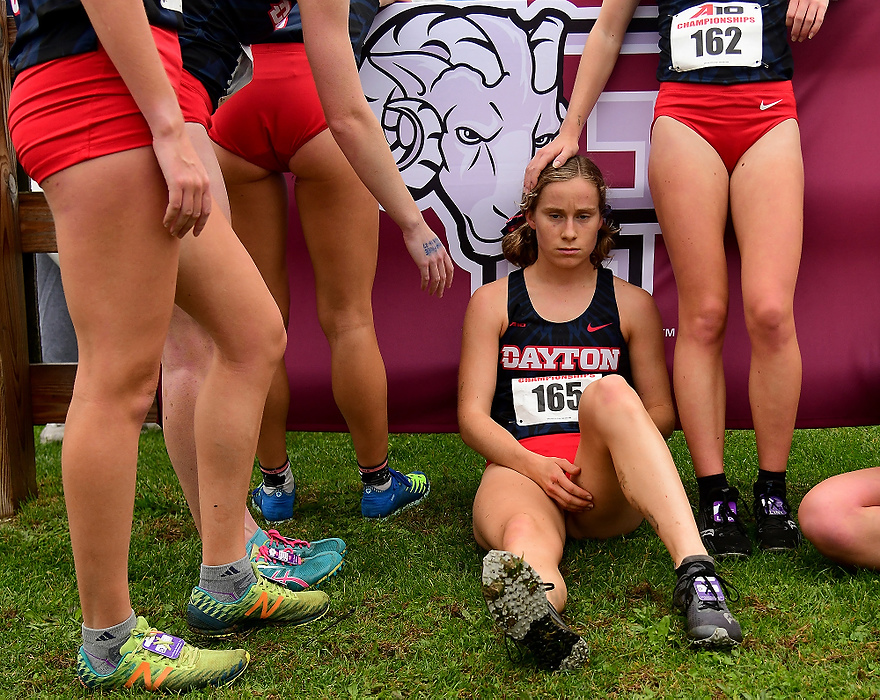 Second place, Sports Feature - Erik Schelkun / Freelance, "Head Pat"Dayton's Hannah Moulton gets a comforting pat on the head after the conclusion of the A10 cross country championship race. Moulton and the Flyers placed 2nd out of 13 teams.