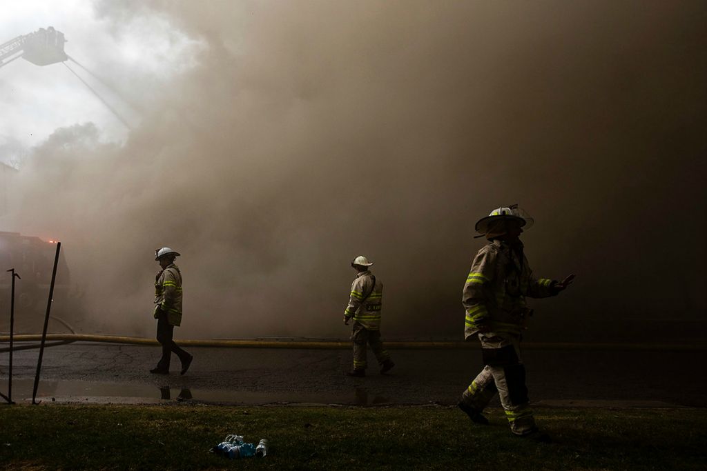 Award of Excellence, Spot News - Rebecca Benson / The Blade, "Apartment Fire"Toledo Fire and Rescue battle an apartment fire on the 5900 block Cresthaven Lane on March 31, 2021. The fire began in the attic and quickly spread throughout the rest of the apartment building due to high winds. Residents were safely evacuated and there were no reported injuries. 